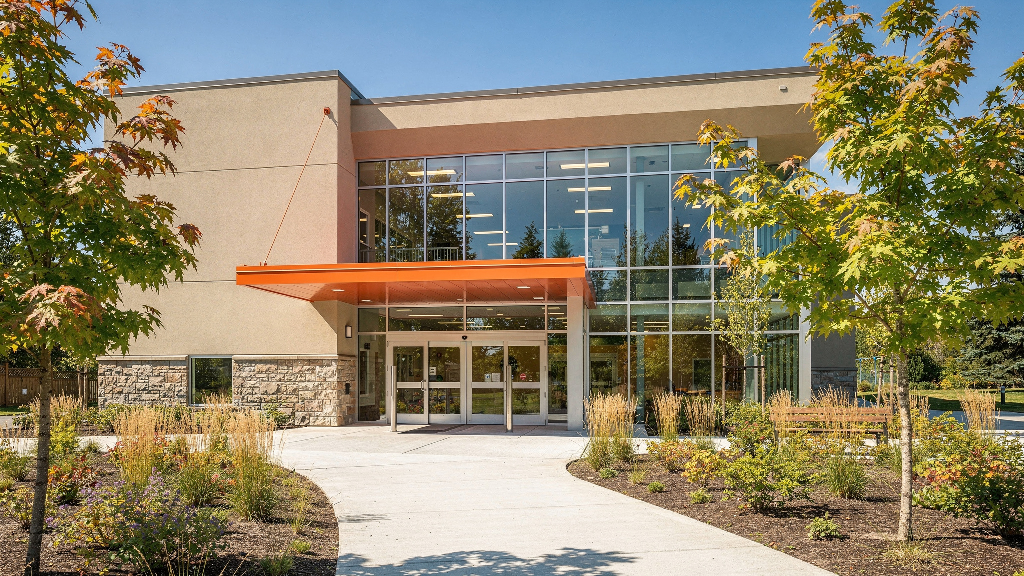 00 featured v2 Vancouver's Top 5 Community Centres, Ranked Modern community recreation centre entrance in Vancouver, BC, with an orange canopy over glass doors.