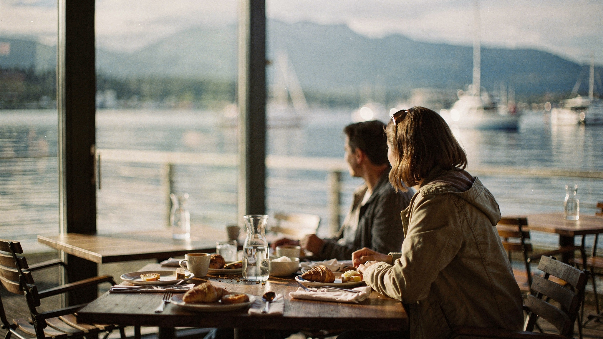 brunch featured vancouver v2 1 Best Brunch in Vancouver, BC Two diners looking out over a Vancouver marina during brunch, seen from behind