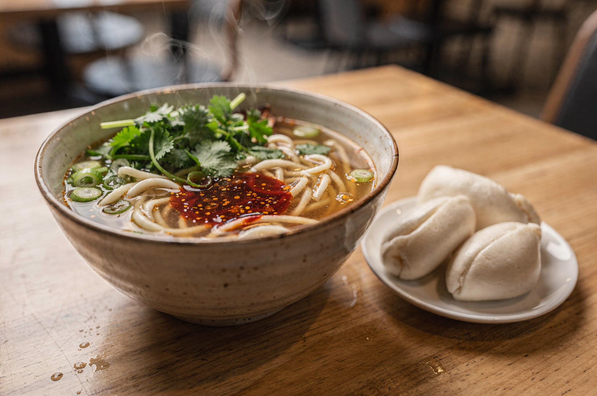budget friendly v2 Downtown Vancouver BC Food Guide Best Restaurants Steaming Asian noodle bowl and bao buns at a quick-service downtown Vancouver restaurant