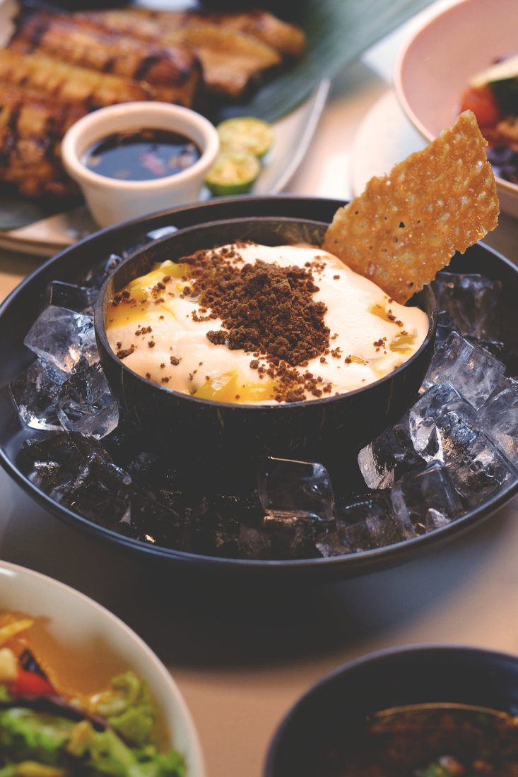 Mango Kilig dessert at Halina, set on ice and topped with crumble and a cookie brittle wafer
